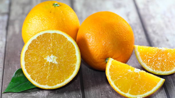 istock Fresh oranges and green leaf on old wooden table, healthy fruit 1345668930