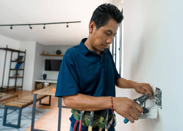 istock Electrician fixing an electrical socket at a house 1345670555