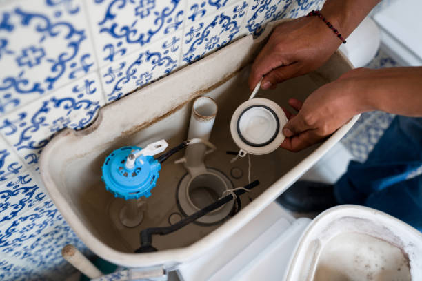 primer plano de un fontanero arreglando un inodoro en el baño - plumber water pipe leaking water fotografías e imágenes de stock