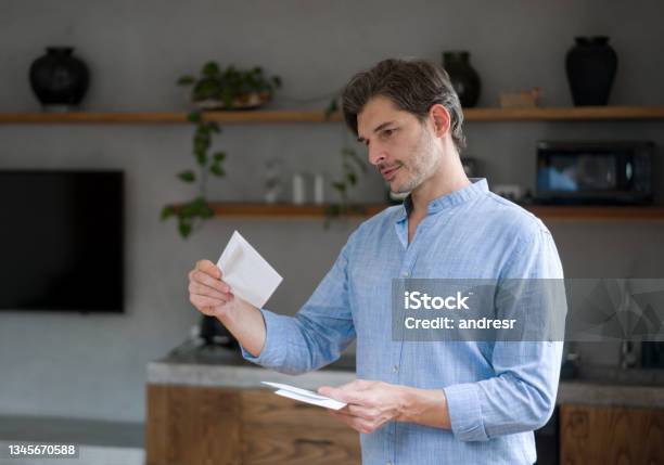 Happy Man At Home Checking Letters In The Mail Stock Photo - Download Image Now - Mail, Letter - Document, Opening