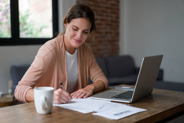 istock Happy woman working at her home office 1345670603