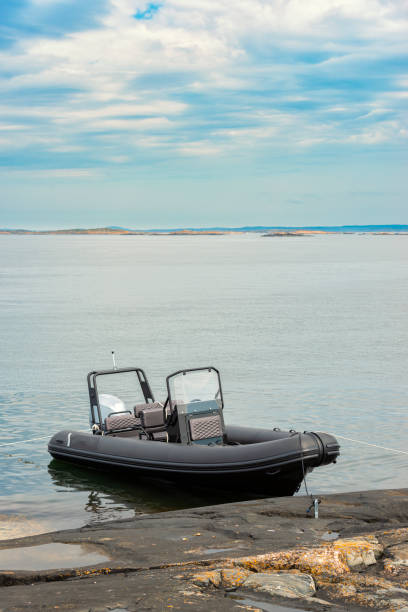 istock Black RIB boat moored at the rocks 1345671787