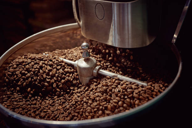 istock Roasting in machine.Coffee beans. Coffee beans in roasting machine. 1345675318