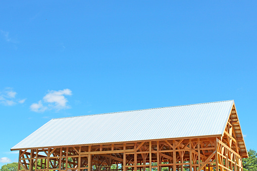 Construction on a new barn with a white metal roof in the country in Ohio, USA