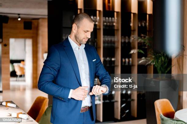 Businessman Checking The Time In A Restaurant Stock Photo - Download Image Now - Businessman, Checking the Time, Meeting