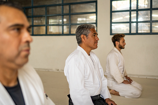 Three men doing concentration exercise