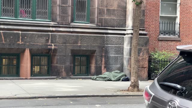 homeless man sleeping outside church in NYC