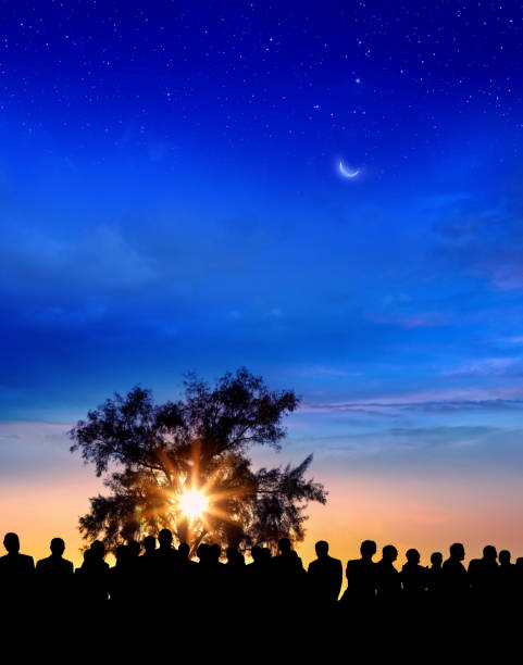 istock Crowd of people watching dramatic colorful sunset 1345679032