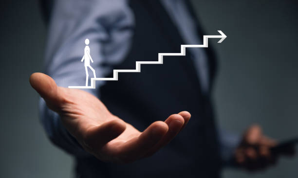 istock man holding phone with stairs icon 1345679990