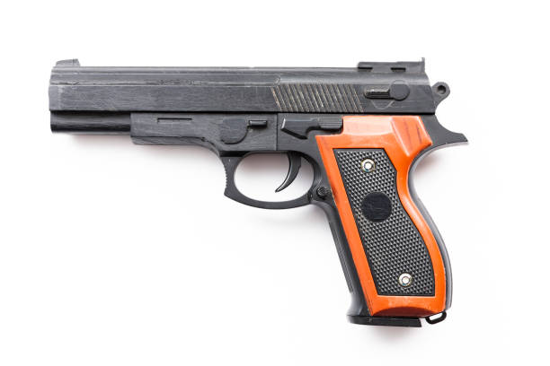 istock Old scratched toy gun against a white background 1345680082