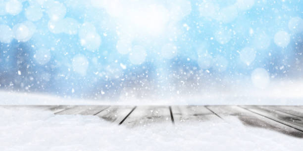 istock Wooden planks against a blurred background with snowflakes 1345680214