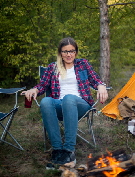 istock Woman resting at camp in the forest 1345680284