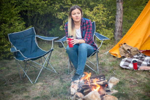 istock Woman resting at camp in the forest 1345680316