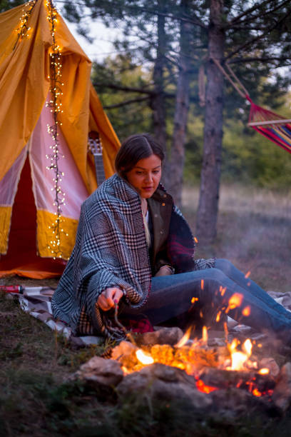 istock Woman resting at camp in the forest 1345680342