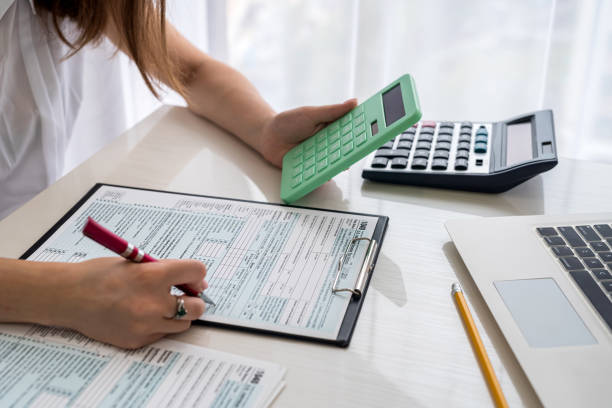 istock Human hands with 1040 tax form closeup 1345680465