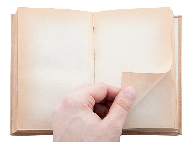 istock Hand turning old blank book page. Clipping path included. 134568067