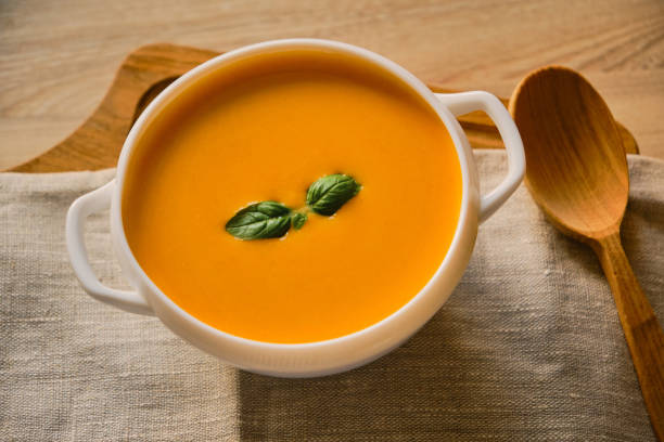 istock Homemade pumpkin soup with basil in a bowl 1345681279