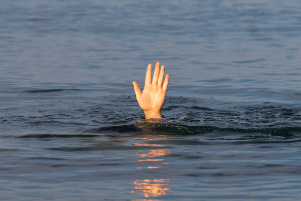 istock Male hand above the water surface. 1345682504