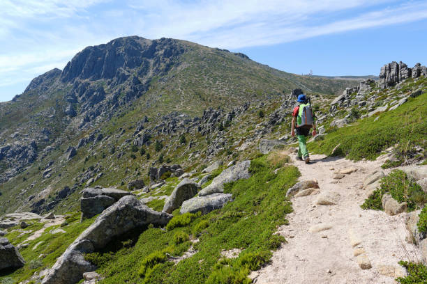 istock Boy with backpack on a hiking trail in the mountains 1345684122