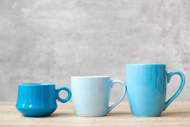 istock Blue coffee cup and tea mug on wood table background in the morning, Blank copy space for text. International coffee day and daily routine concept 1345685018