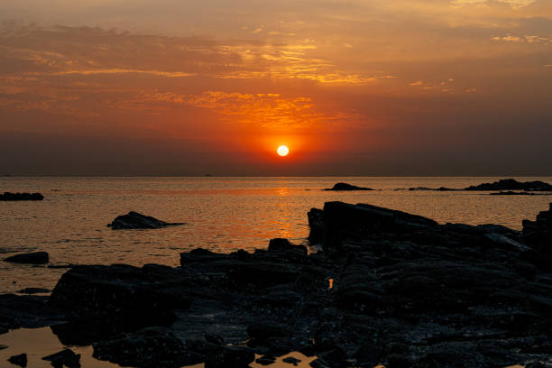 Sunlit reefs and ships at seaside in the morning