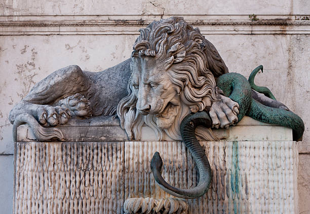 Lion and Serpent Fountain, Grenoble la fontaine du serpent et du lion, or The Lion and The Serpent fountain stands in the Saint Laurent quarter of Grenoble, France at the Place de la Cimaise. The Lion is thought to represent either the river Drac or the city and the Snake represents the river Isère. It was sculpted by Victor Sappey. isere river stock pictures, royalty-free photos & images