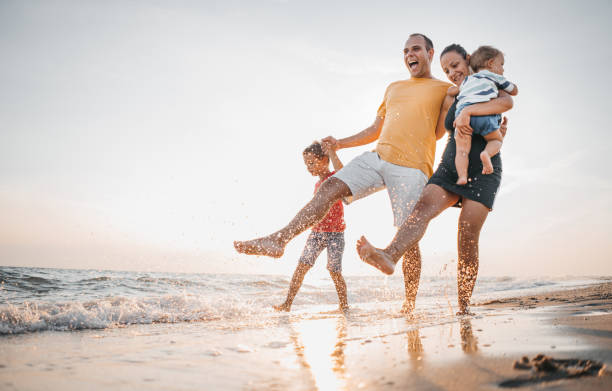 istock Family walking on the beach 1345687487