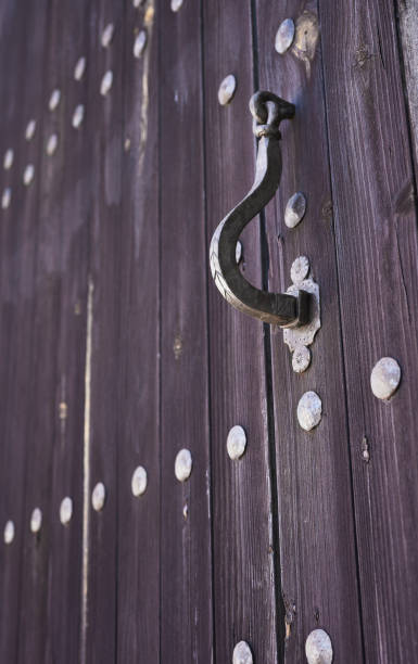istock knocker on old wooden door 1345687558