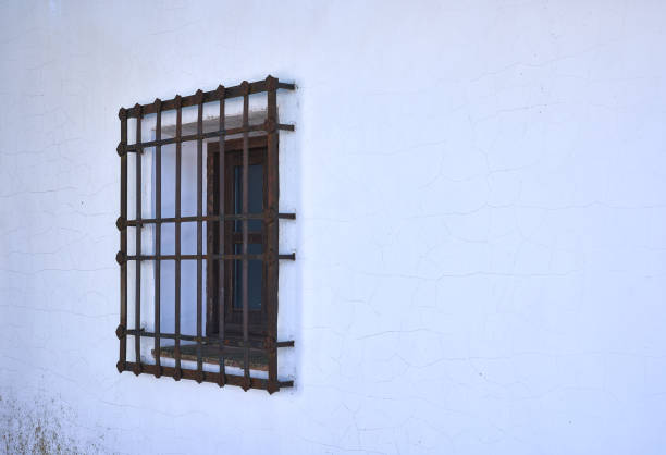 istock window with a forged grille in a Castilian house 1345687570