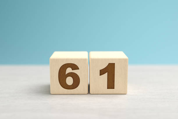 istock Wooden toy blocks forming the number 61. 1345688441