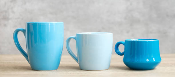 istock Blue coffee cup and tea mug on wood table background in the morning, Blank copy space for text. International coffee day and daily routine concept 1345688504