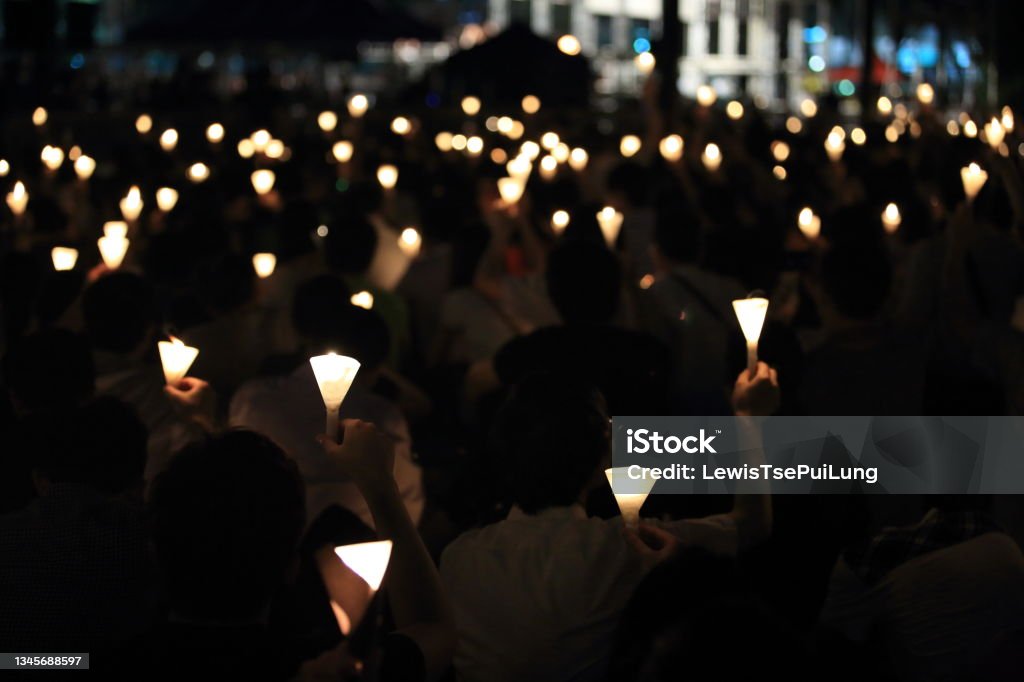 finding the light in dark. a haza candlelight vigil find each other in darkness, blur background in hong kong victoria park Candle Stock Photo
