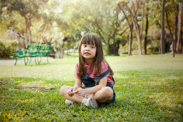 istock Children sitting in the garden. 1345689254