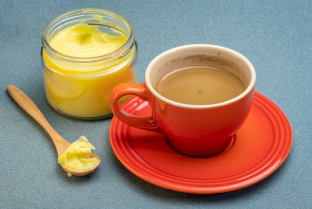 cup of fresh fatty coffee with ghee cup of fresh fatty coffee with ghee (clarified butter) and MCT oil - ketogenic diet concept ghee stock pictures, royalty-free photos & images