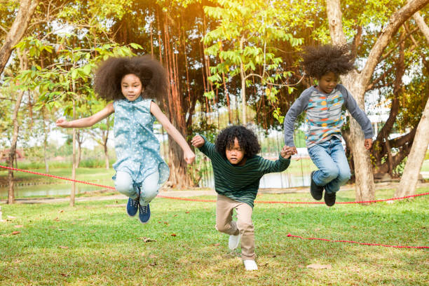 istock Children jumping over the rope in the park 1345689576