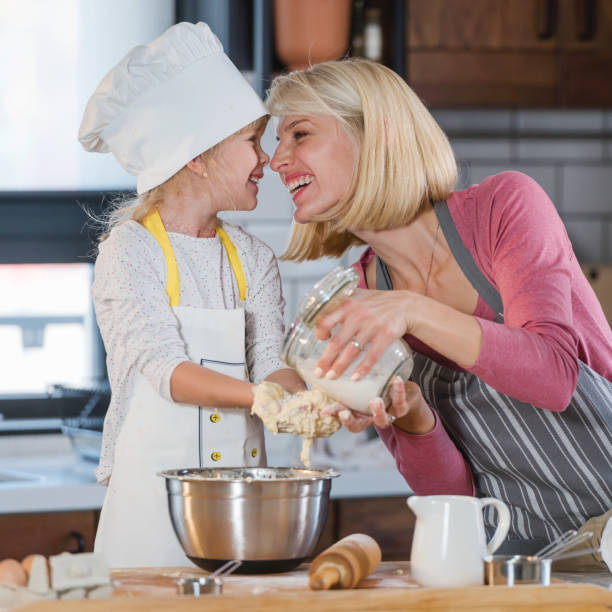 istock Mother spending quality time with a child in the kitchen baking a cake 1345689756