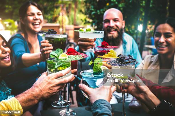 Fashionable People Holding Multicolored Drinks Trendy Friends Having Fun Together Drinking Cocktails At Happy Hour Social Gathering Party Time Concept On Vintage Filter And Shallow Depth Of Field Stock Photo - Download Image Now