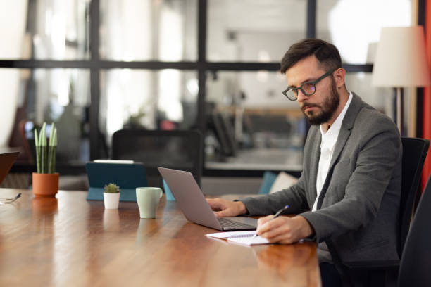 istock Young Caucasian businessman working in the office 1345690500