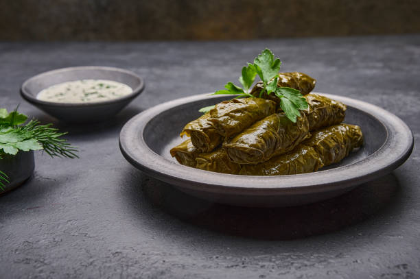 istock Close up dolma with sour cream on ceramic color graphite plate 1345690620