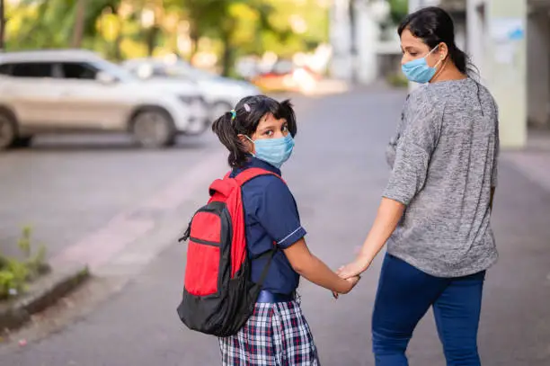 Photo of Back to school- Asian / Indian mother leaving her daughter for school, School open after slowdown of Corona virus pandemic.