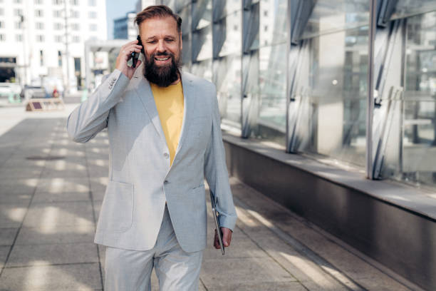 istock Entrepreneur talking on cell phone on the way to office 1345691996