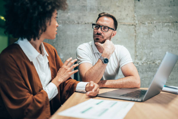 istock Two business people working together in office 1345694634