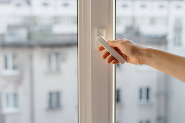 Woman open pvc window with double glazing