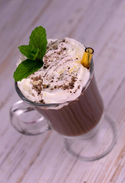 istock Glass of chocolate drink with whipped cream. Flat lay. Selective focus. 1345697691