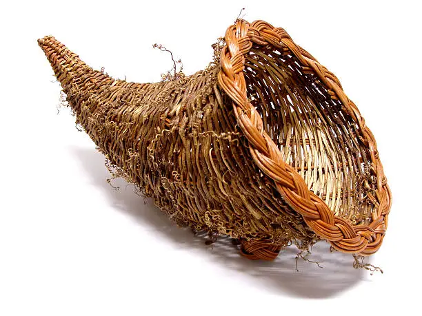 Empty cornucopia basket for thanksgiving over a white background