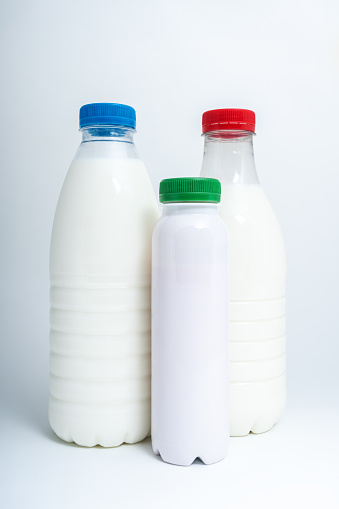 Milk and yogurt plastic bottles on white background