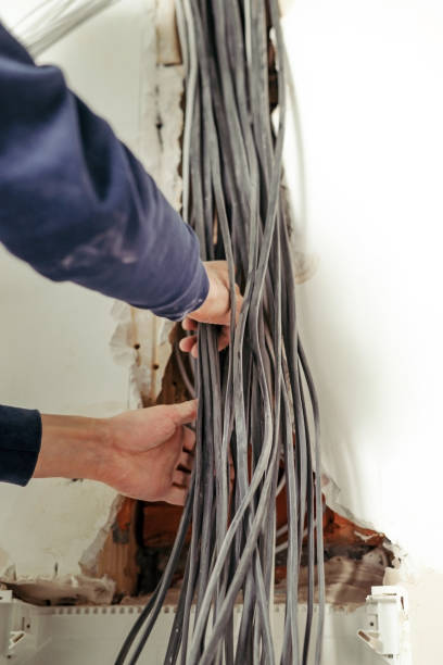 istock Electrical wires in the electrical panel. Repair in the apartment. Connecting the light. Professional installation of electrical outlets, wires and switches. 1345702359