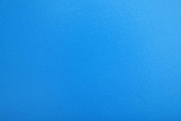 istock Abstract blue glossy paper texture background or backdrop. Blank wrapping paper or shiny cardboard for a decorative design element. Grainy surface. 1345706061