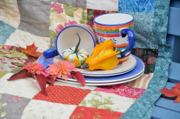 istock Backyard fall harvest decorations on sheltered patio swing bench with cozy blankets for cool autumn days and hot beverage 1345708307