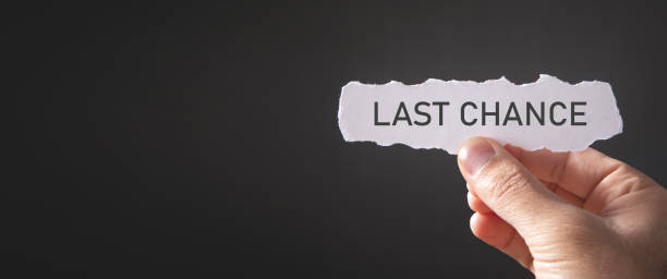 istock Male hand showing Last Chance message on torn paper. 1345710398